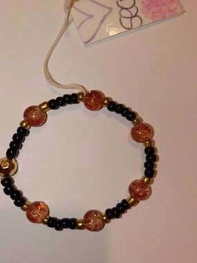 Handmade Black and Gold Beaded Bracelet with Amber Glass Accent